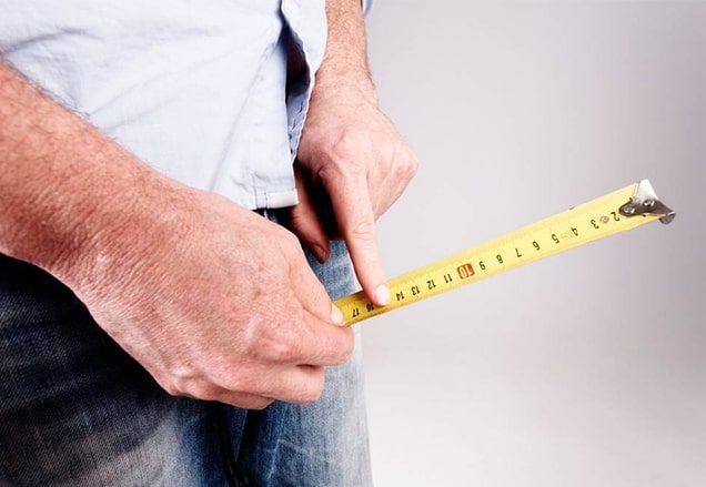 A man checking the size of his penile implant.