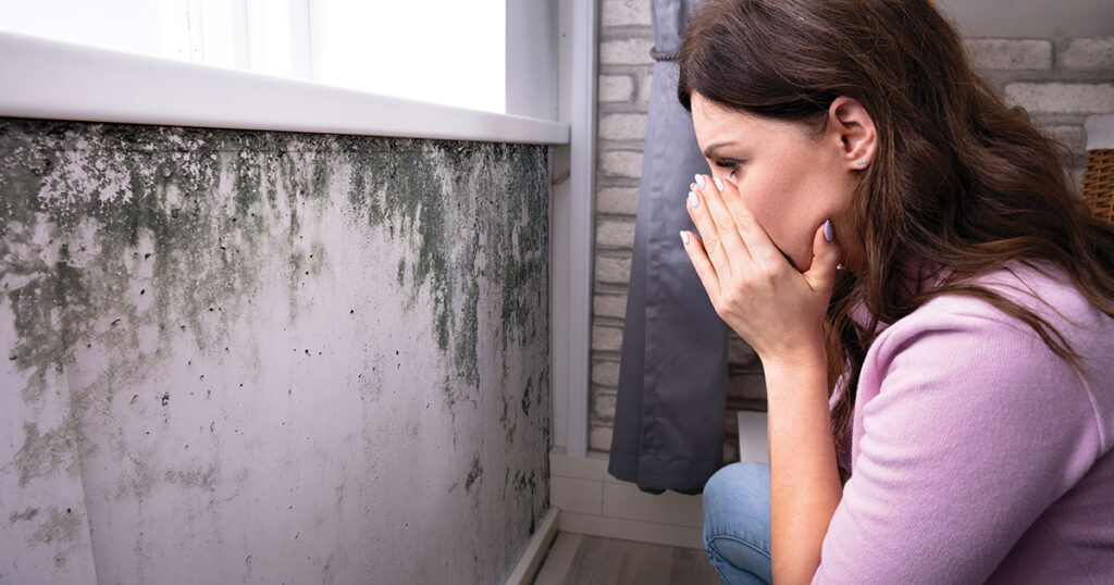 girl covering her nose against mold spores