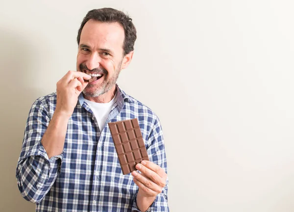 Man eating appropriate amount of dark chocolate for prostate health 