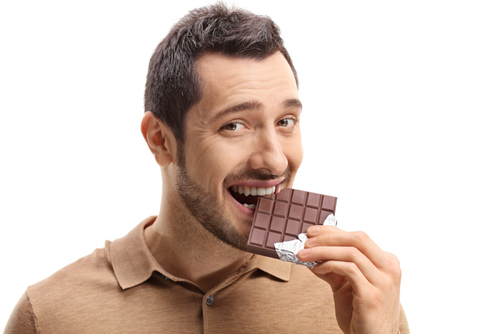 Young Man eating dark chocolates for prostate health