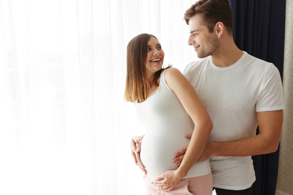 Man and pregnant wife happy over the outcome of tens pad for erectile dysfunction