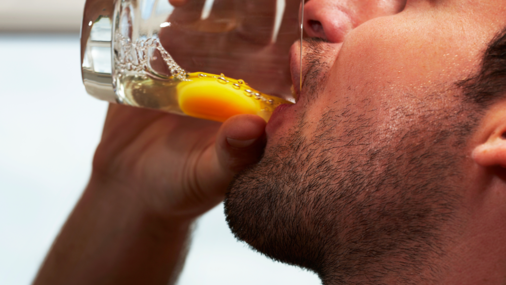 Man drinking raw eggs for testosterone increment