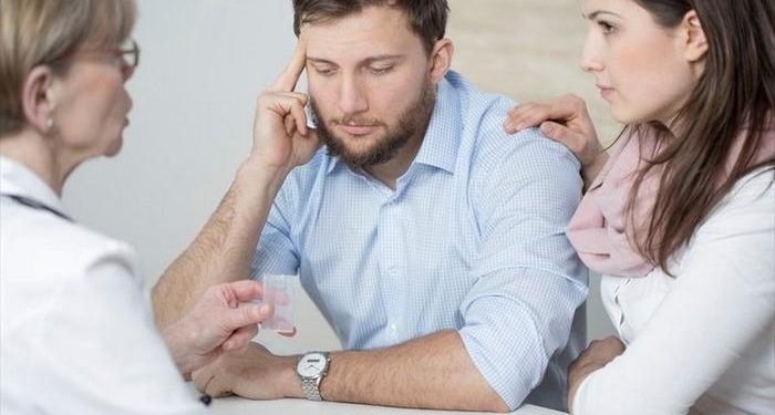 man and woman consulting a doctor about infertility