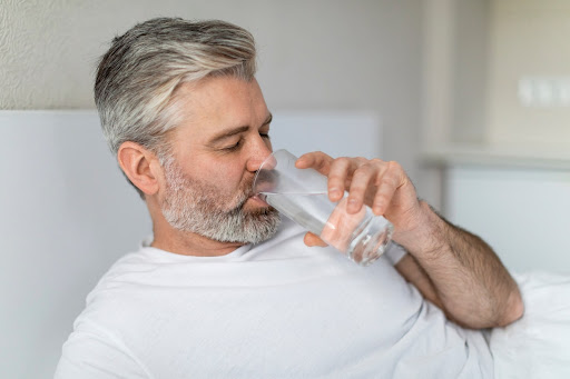 Man drinking water for sperm count and motility