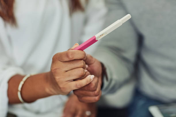 man and woman holding ovulation test strip