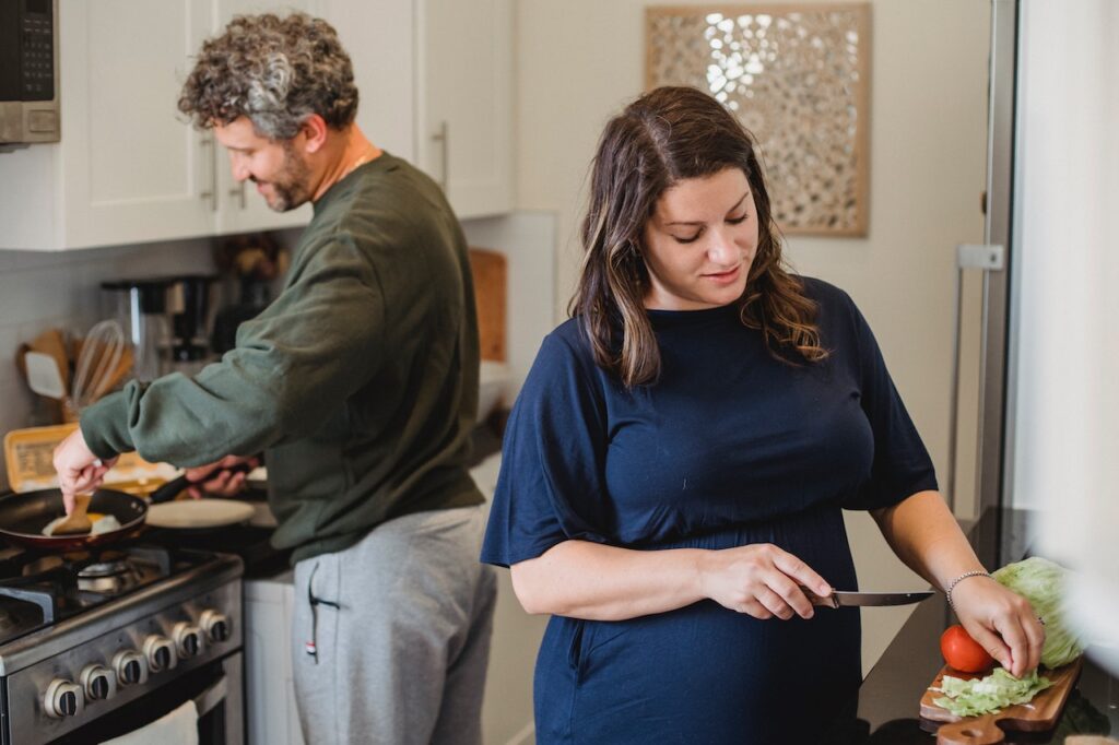 husband and wife preparing postpartum meals