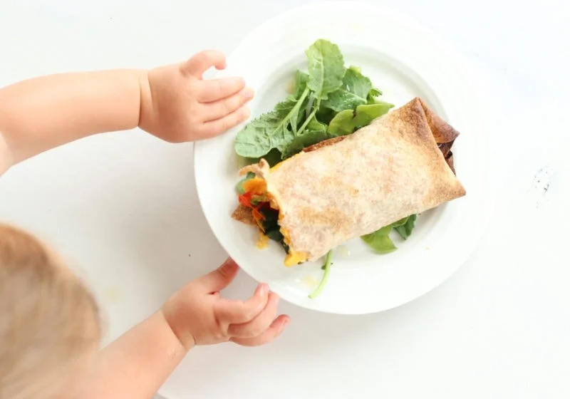 baby touching a meal for postpartum recovery 