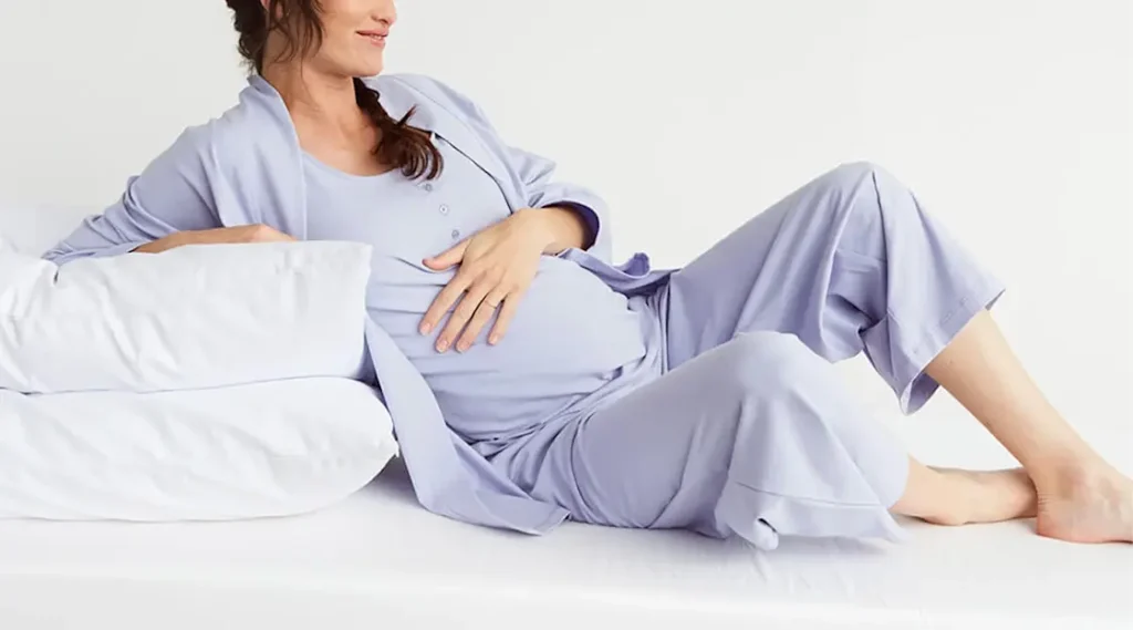 new mom putting on  loosed fitting pajamas