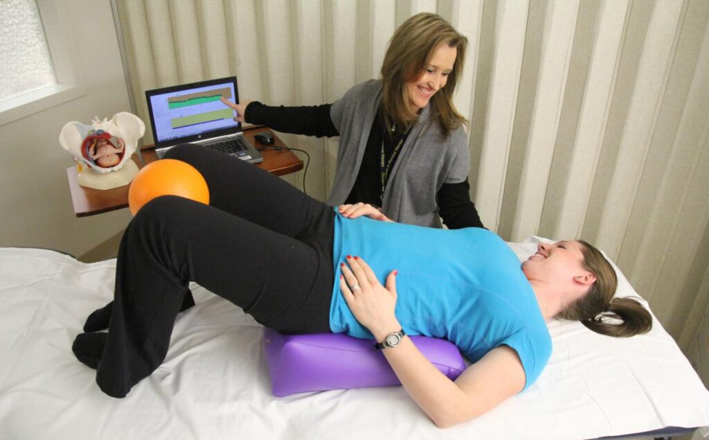 Healthcare provider helping a woman with pelvic floor exercises