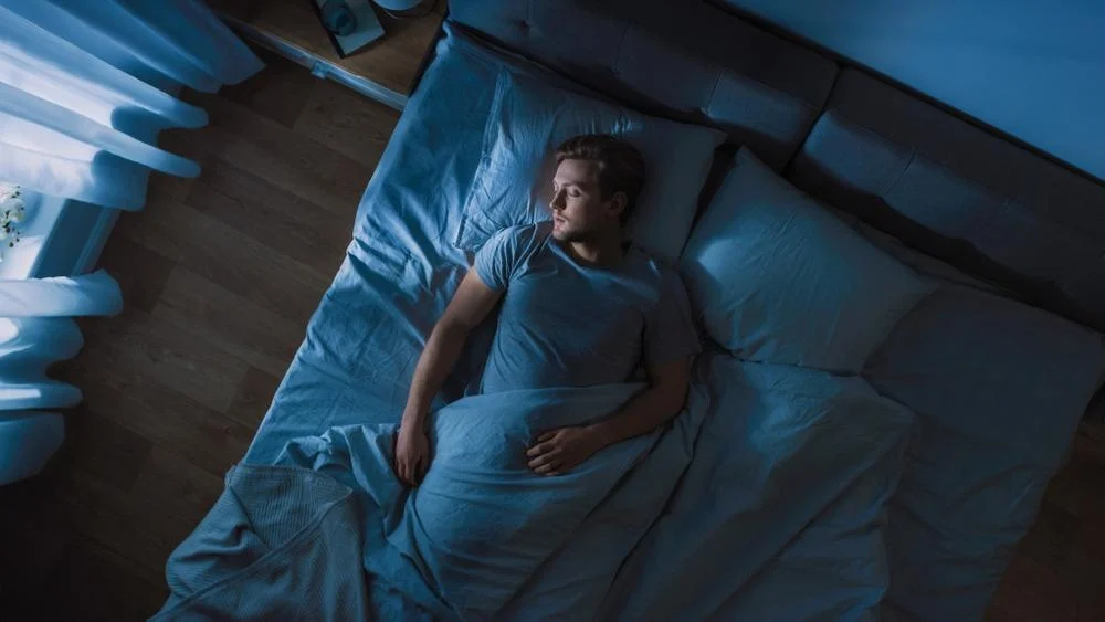 man sleeping comfortably after quitting smoking