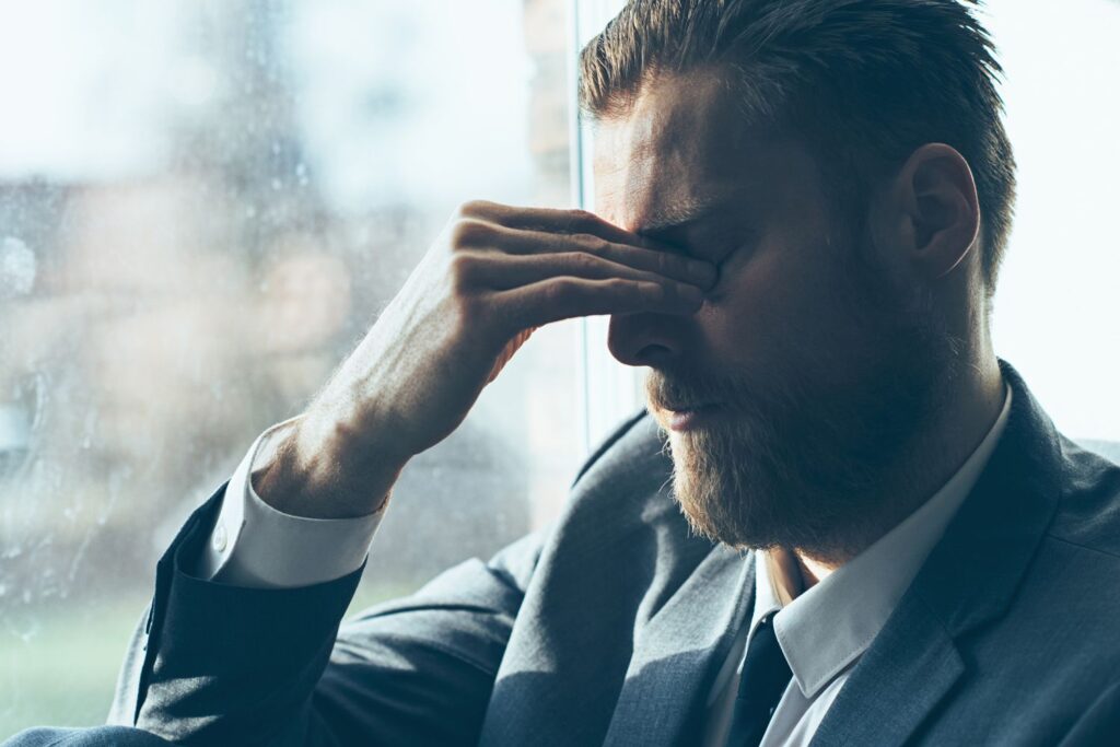 man experiencing headaches due to stress