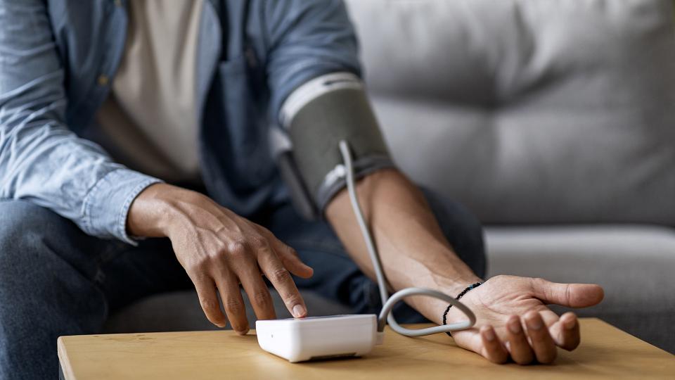 man checking his blood pressure after taking erectile dysfunction pills