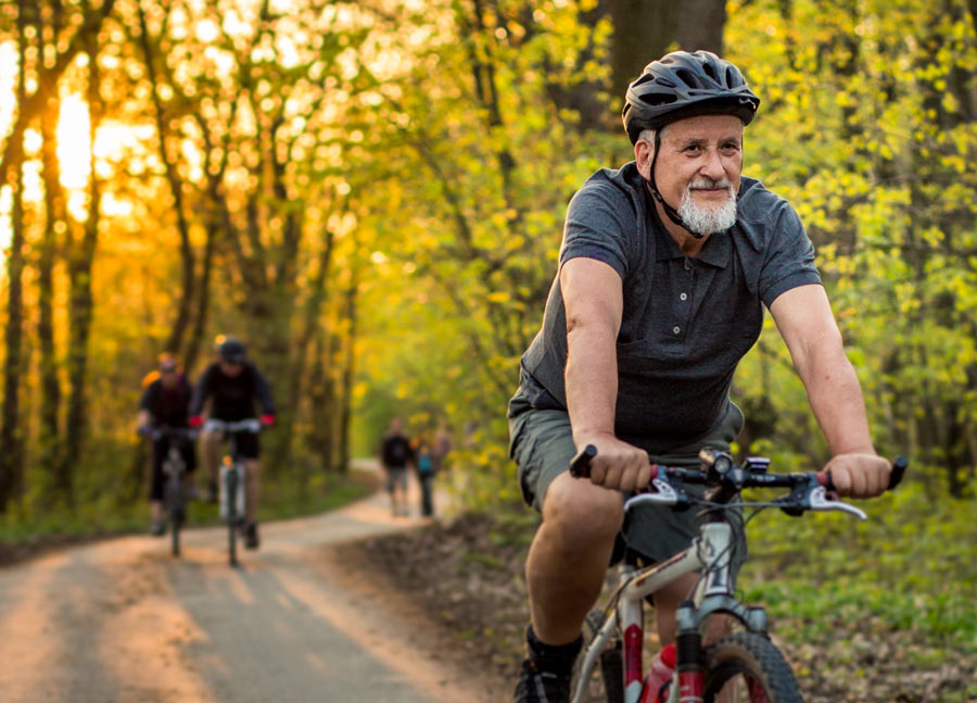 old man riding a bicycle freely without discomfort