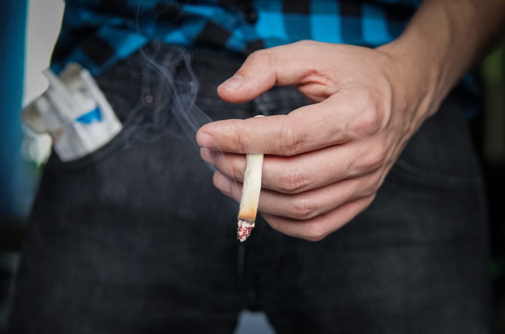 man holding a cigarette
