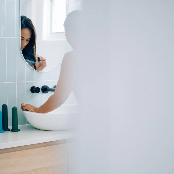 woman preparing a vaginal dilator for use