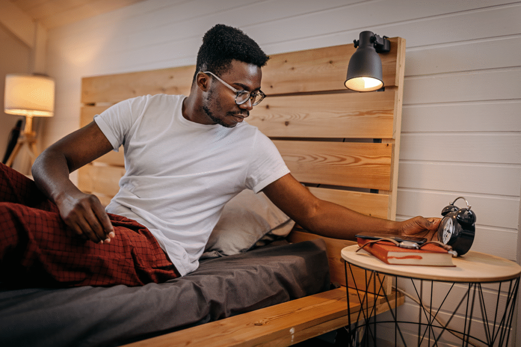 man trying to set the alarm before sleeping