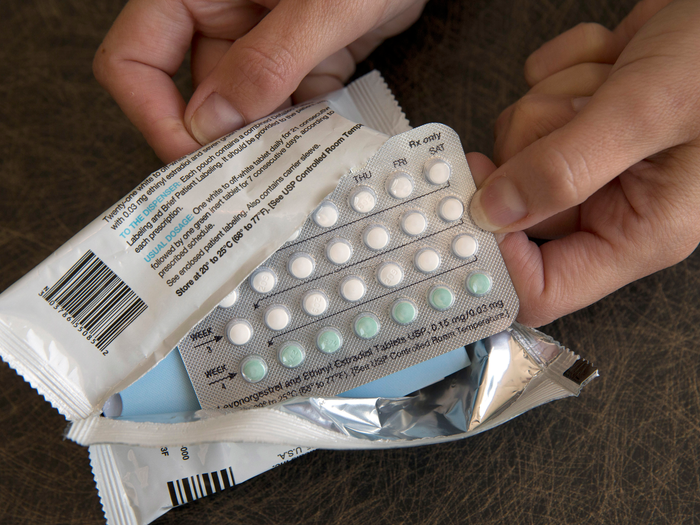 lady opening a new birth control pill