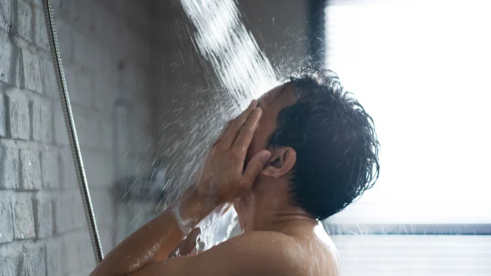 young man enjoying cold showers