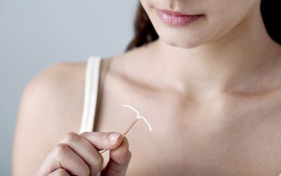 lady holding an IUD