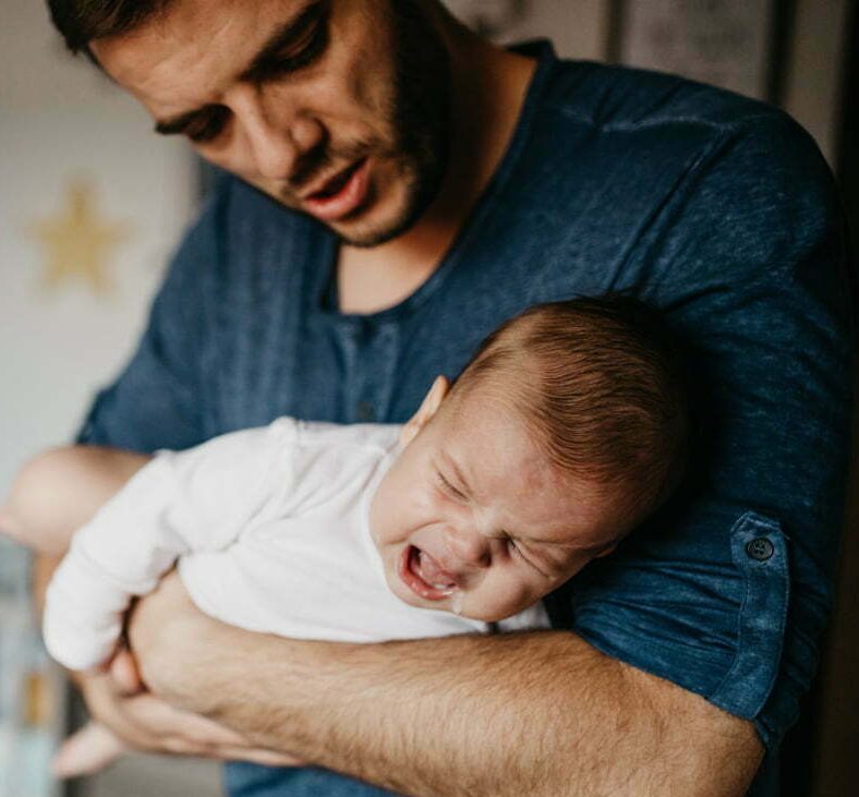 man suffering from postpartum depression