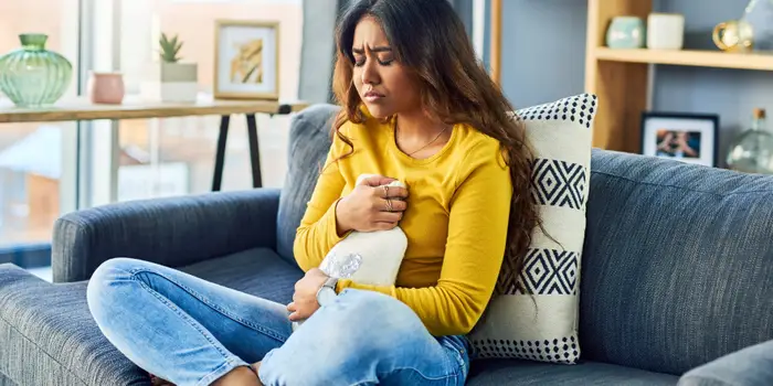 woman trying to soothe pain from IUD implant