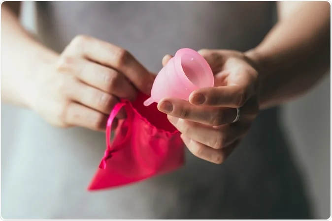 Lady holding a menstrual cup