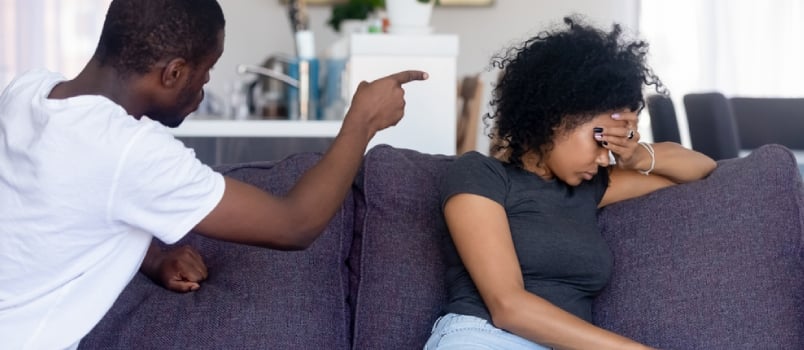 man pointing fingers angrily at wife
