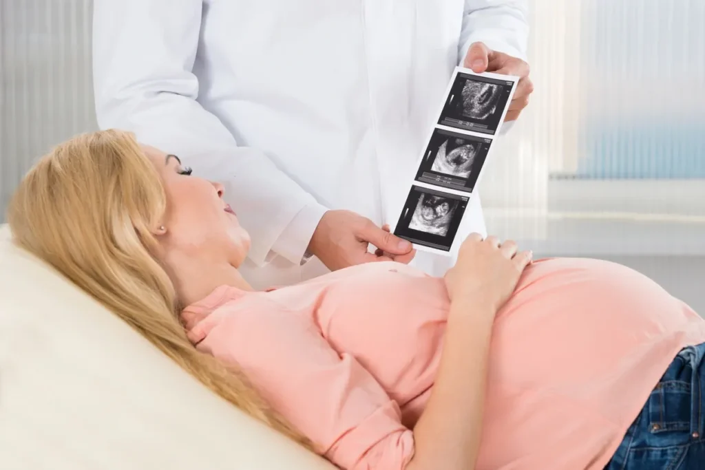 doctor showing scan resuls to pregnant patient