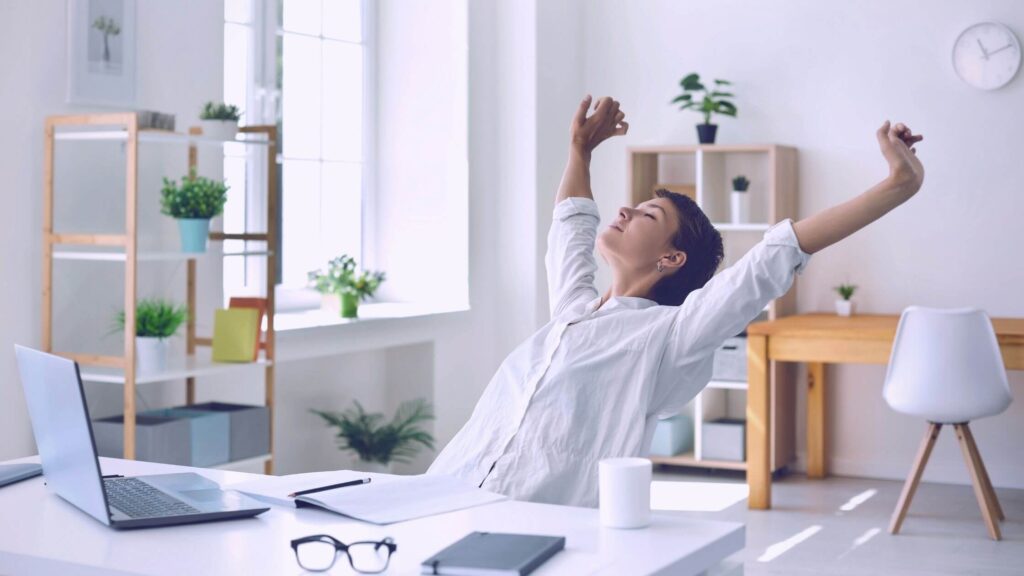 woman stretching after sitting for long at work