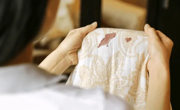 woman holding a stained clothe
