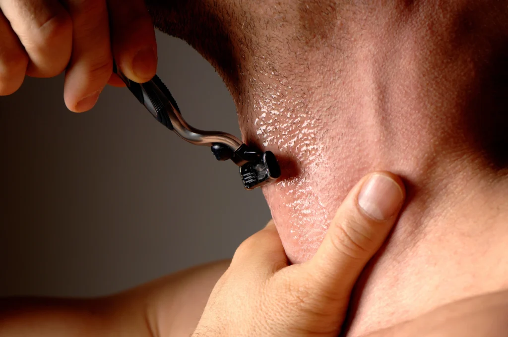 young man shaving off his beards