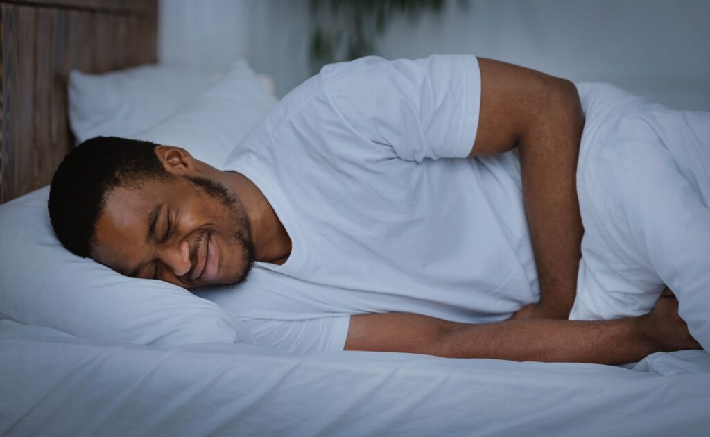 man holding his stomach in pains