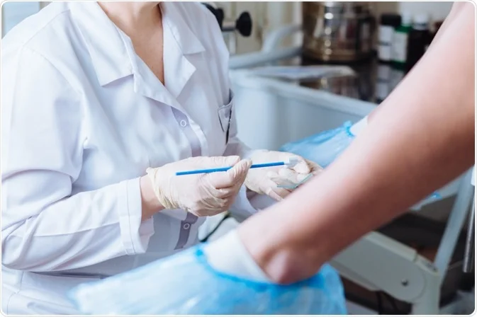 doctor performing pap smear test