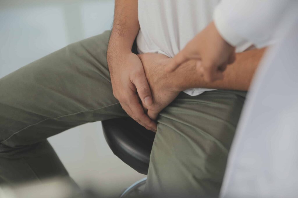 man clutching his scrotum