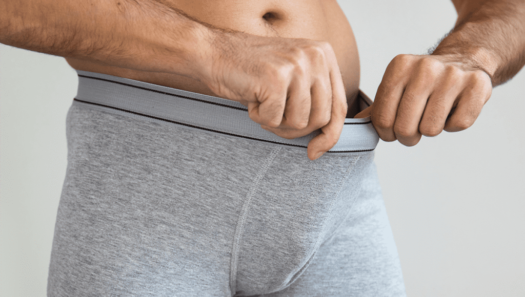 man checking his genitals