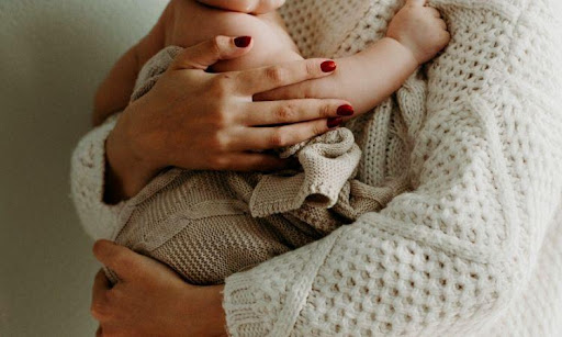 young monm holding a child