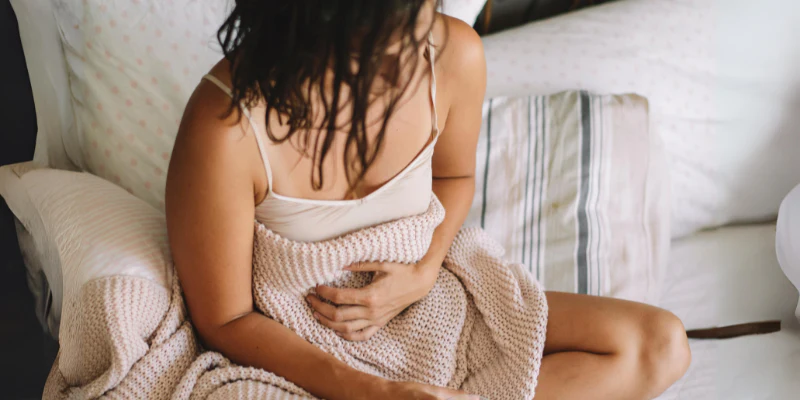 woman experiencing stomach pain after sex